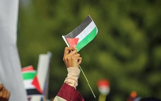 علم فلسطين في يد سيدة فلسطينية